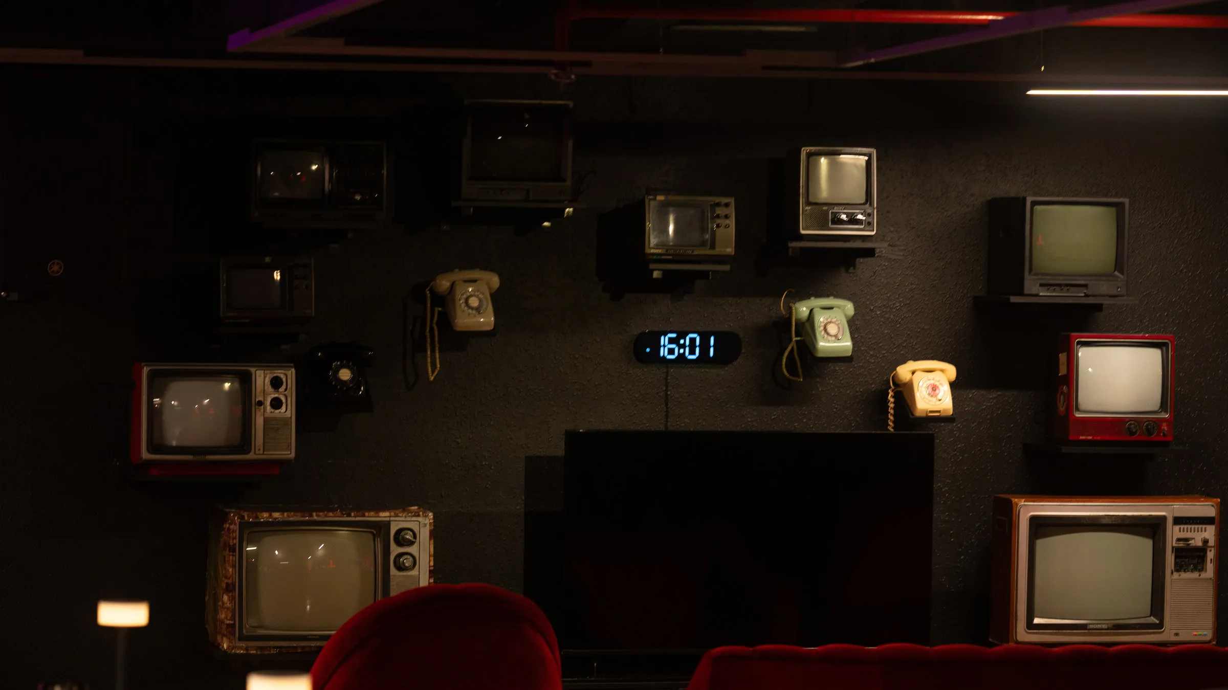 Retro televisions and rotary phones on the Night Shift wall