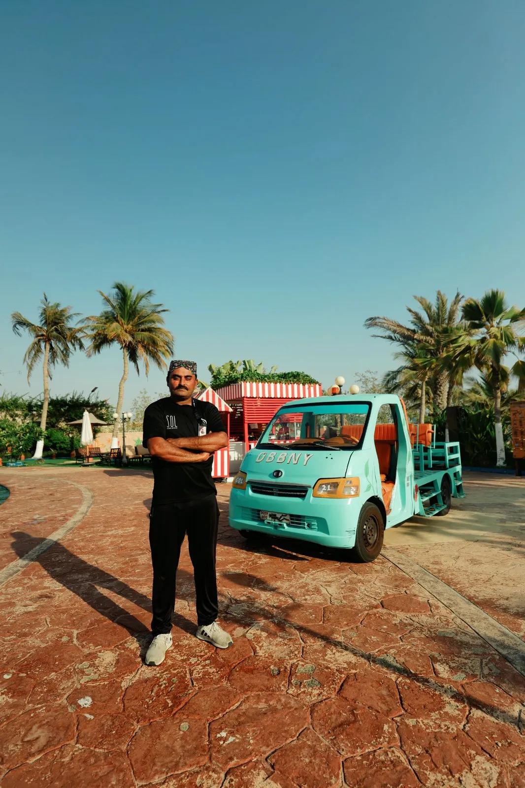 A SOL captain beside the resort buggy